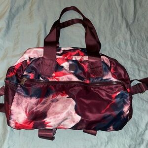 JoyLab Red and Pink Travel Bag with Artistic Floral Design
